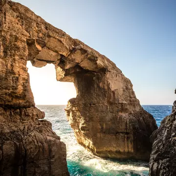 The stone arch at Wied Il-Mielaħ, accessible to hikers, mountain bikers and rock climbers. Ramon Portelli / Getty Images