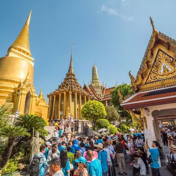 Many Tourists gather around Wat Phra Kaew, the Temple of Emerald Buddha at Bangkok's Grand Palace