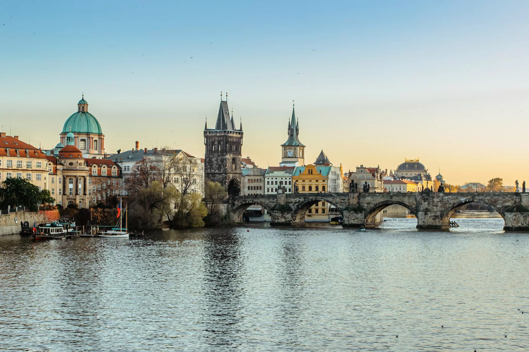 A bridge over a river to a historic city.