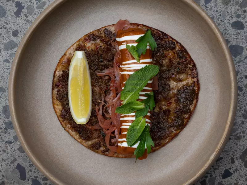 A barbecued flatbread on a plate