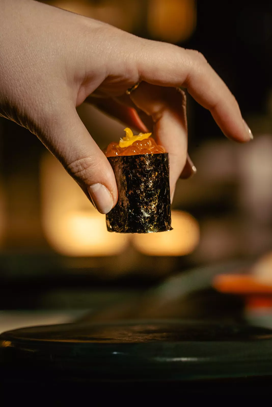 Hand holding a bite-sized appetizer