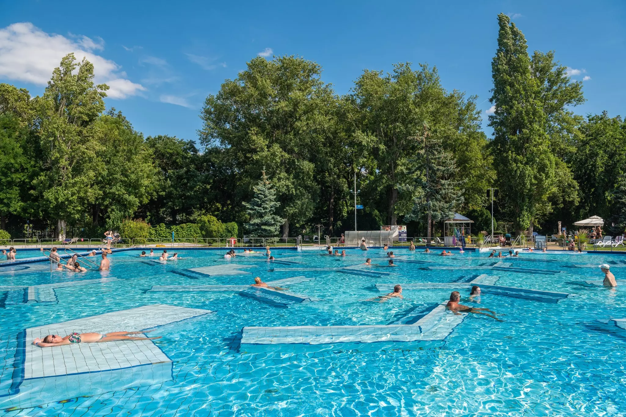 People swimming in the thermal pool at Palatinus Strand on Margaret Island in Budapest, Hungary.