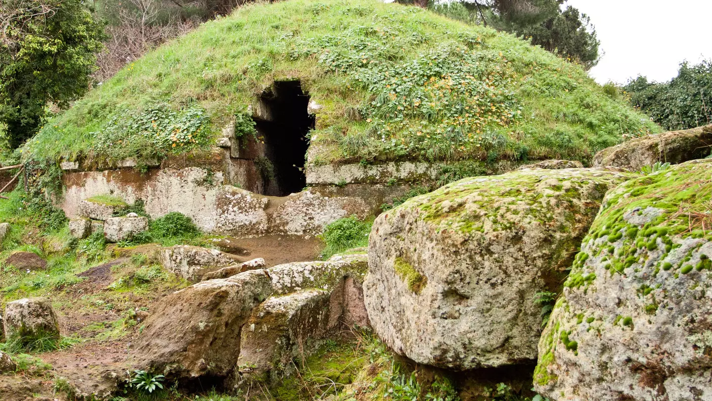Grass and moss cover stone tombs at the Etruscan necropolis of Cerveteri