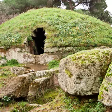 Grass and moss cover stone tombs at the Etruscan necropolis of Cerveteri