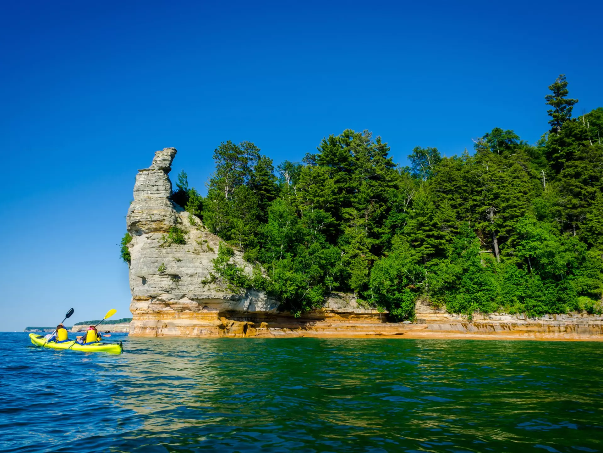 Kayakers in Pictured Rocks National Lakeshore, Michigan. KYPhua/Shutterstock