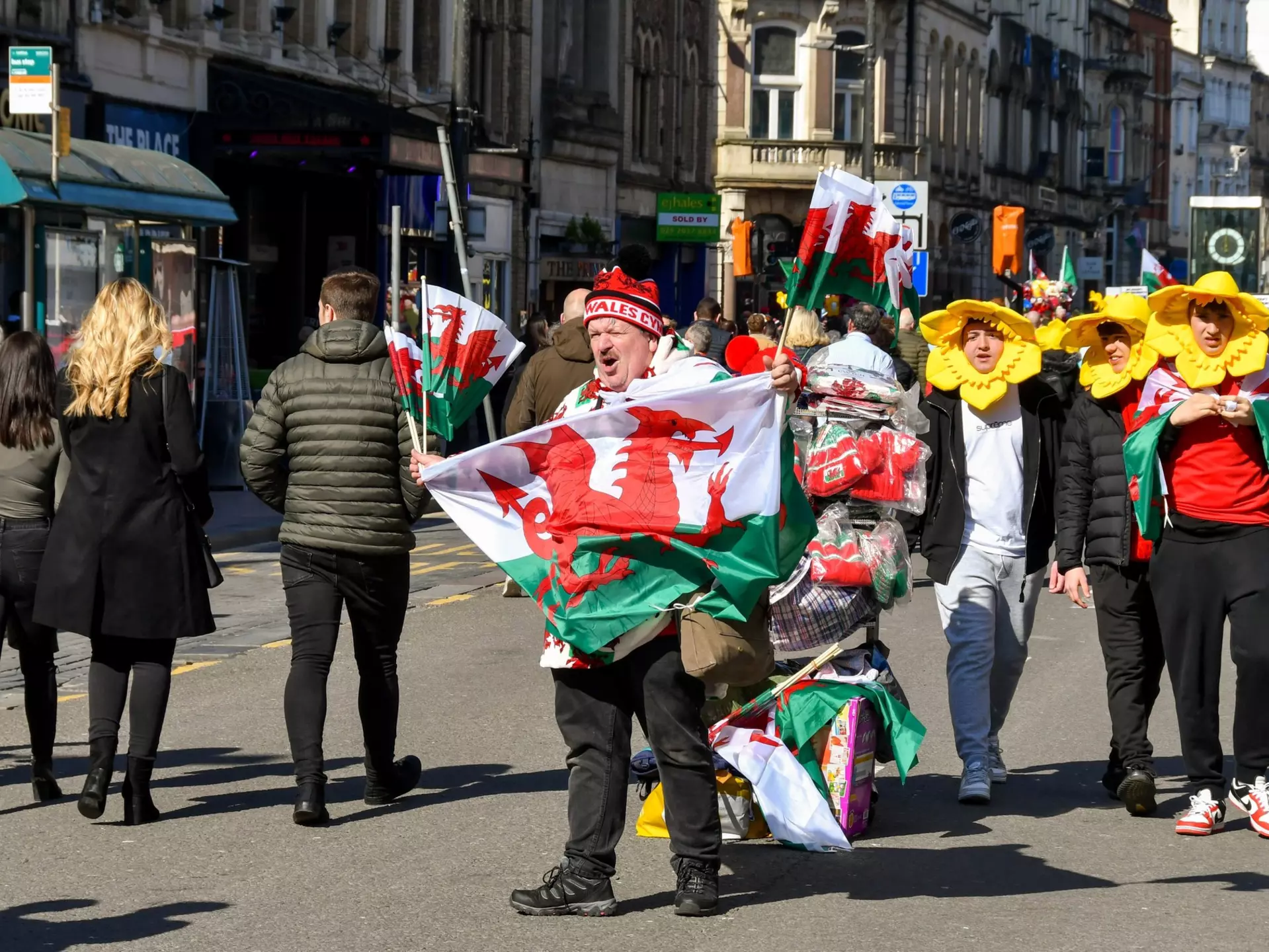 Cardiff, Wales - March 2022: Street trader selling Welsh flags ro rugby fans in Cardiff city centre on match day  License Type: media  Download Time: 2022-04-22T12:41:19.000Z  User: gwencotter  Is Editorial: Yes  purchase_order:   