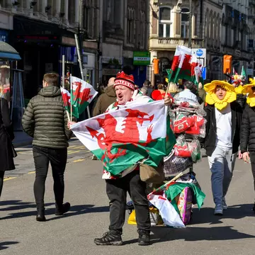 Cardiff, Wales - March 2022: Street trader selling Welsh flags ro rugby fans in Cardiff city centre on match day  License Type: media  Download Time: 2022-04-22T12:41:19.000Z  User: gwencotter  Is Editorial: Yes  purchase_order:   