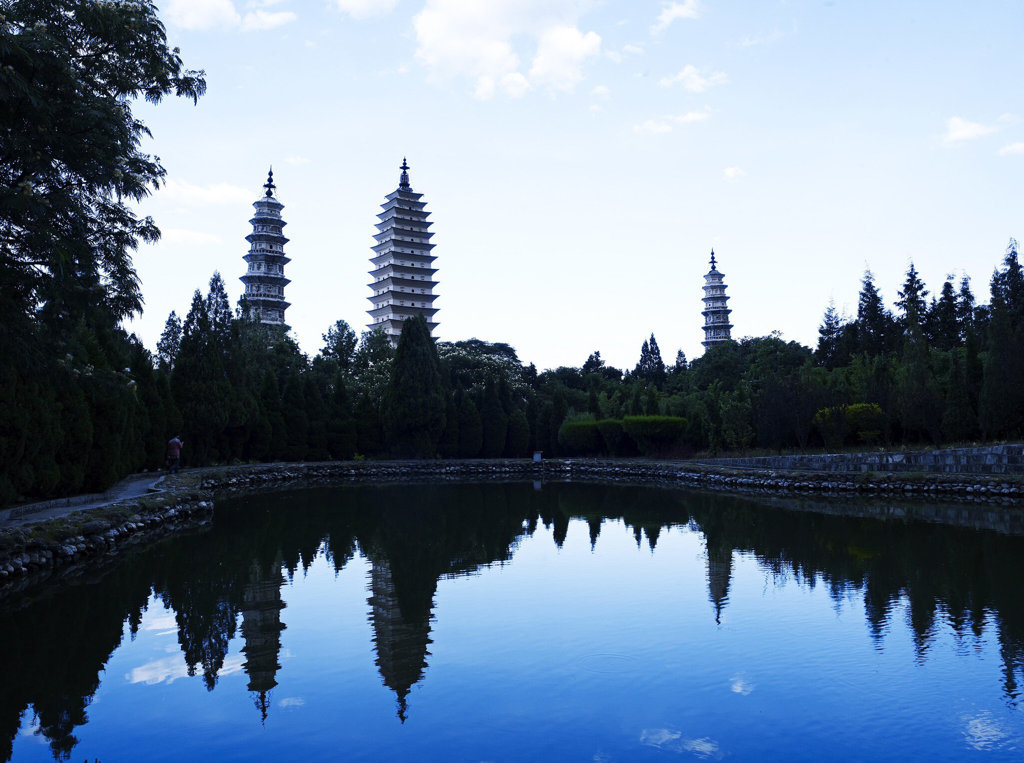 Three Pagodas visible across a pond.