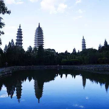 Three Pagodas visible across a pond.