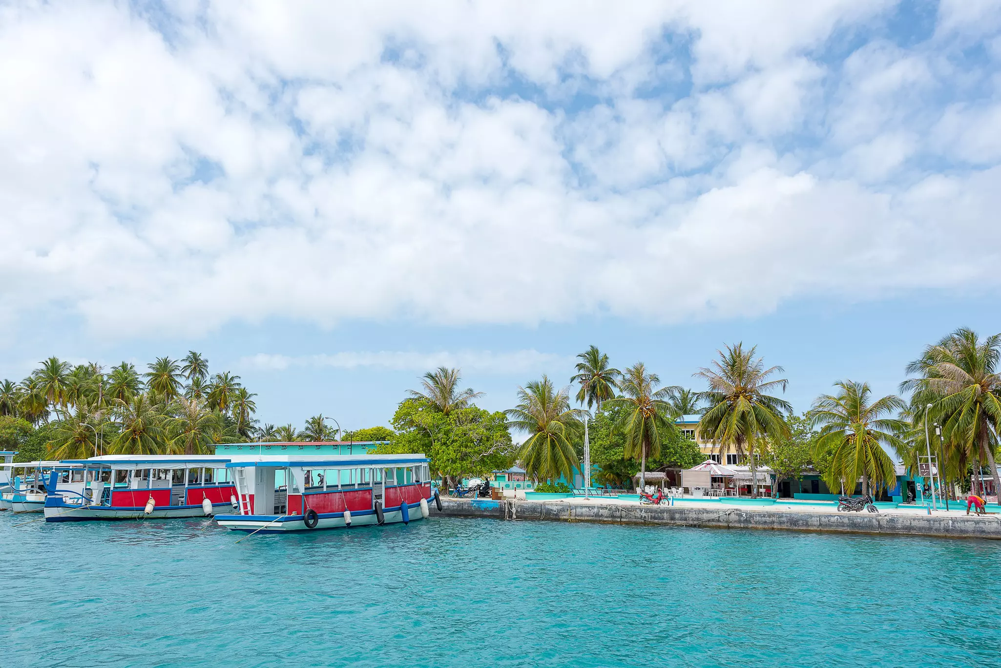Small passenger boats docked at the port of Himmafushi.