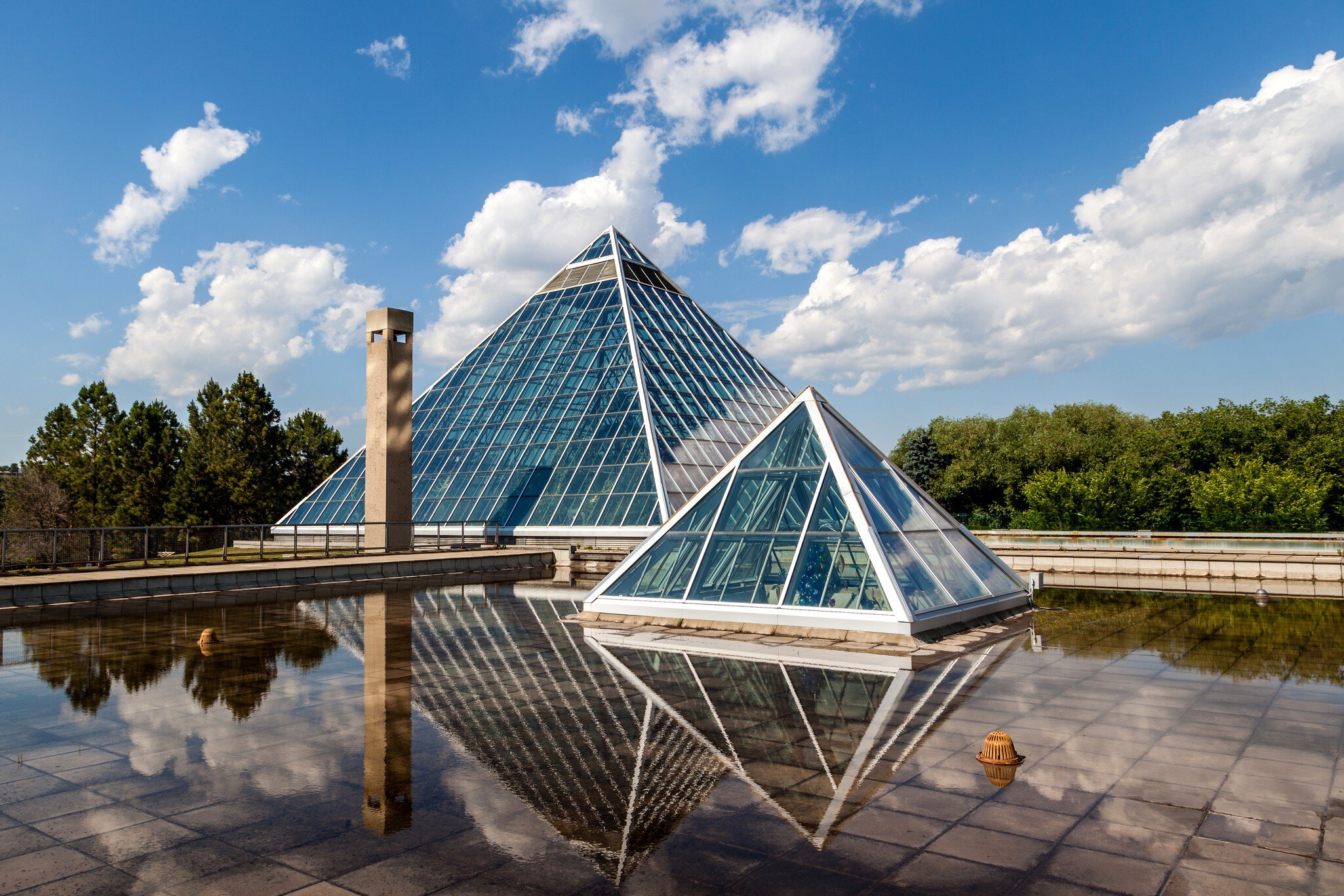 Edmonton, Canada - July 8, 2014: A Summer view of the Muttart Conservatory, one of Edmonton's most famous icons built in 1976 by architect Peter Hemingway. The conservatory features unique greenhouses and gardens that display plant species found a...