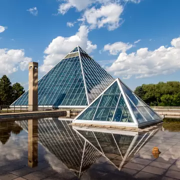 Edmonton, Canada - July 8, 2014: A Summer view of the Muttart Conservatory, one of Edmonton's most famous icons built in 1976 by architect Peter Hemingway. The conservatory features unique greenhouses and gardens that display plant species found a...