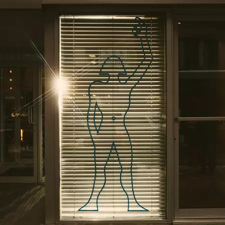 Outline of a dancer on a window at night