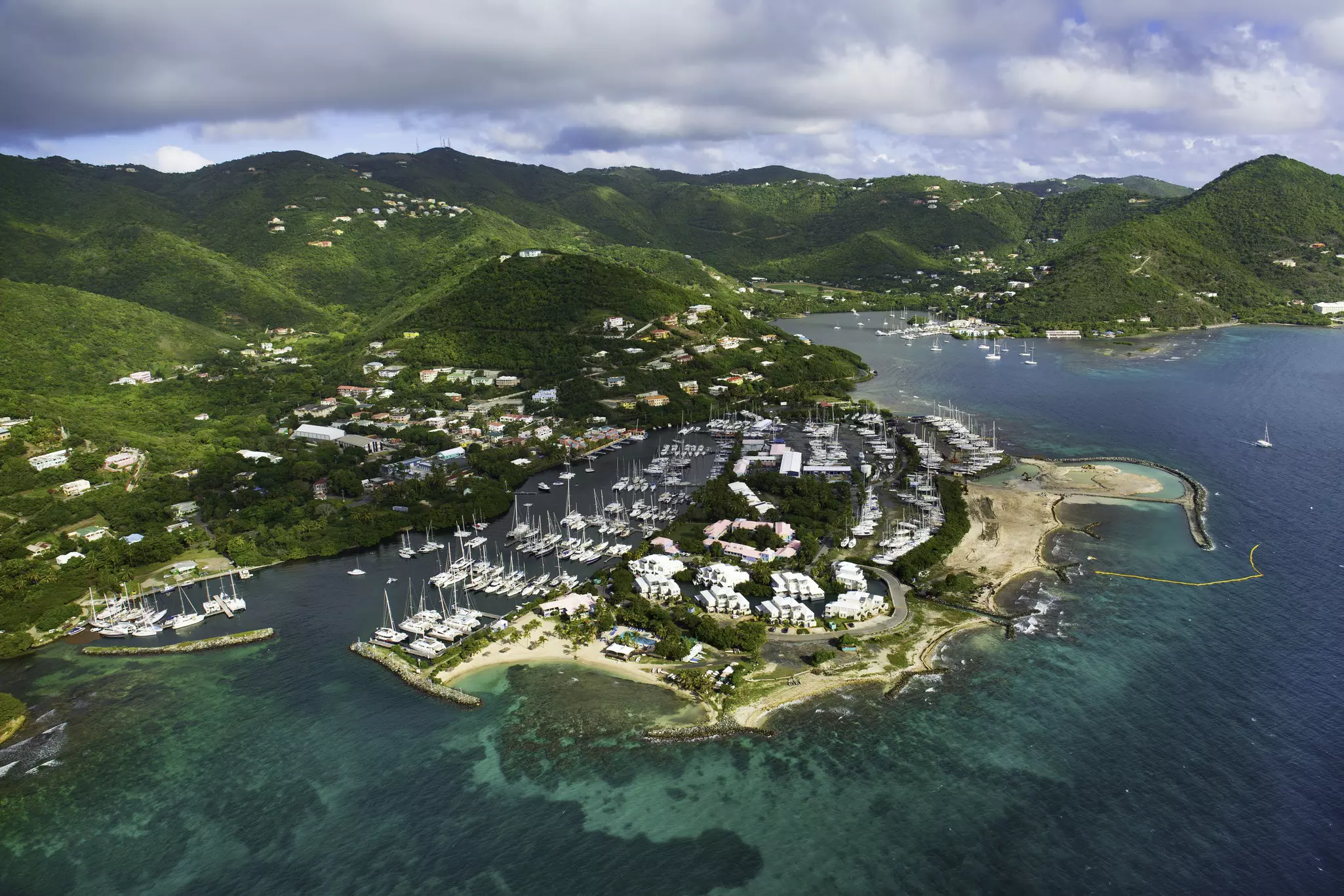 Many catamarans docked in a small island harbor