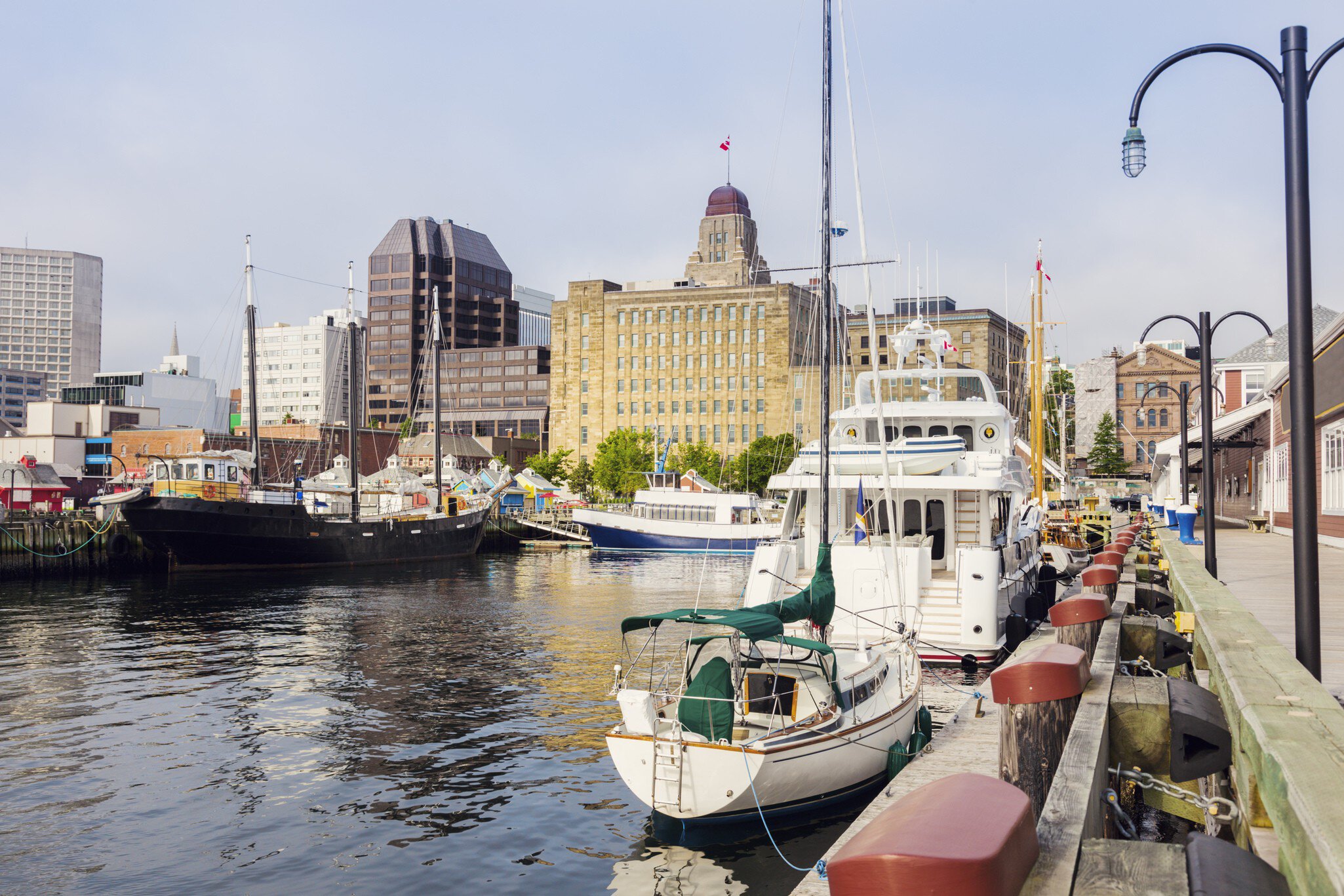 Boats docked at the harbour in Halifax.
900662552
Outdoors, Day, Downtown District, Summer, Halifax Regional Municipality - Nova Scotia, City Life, Sunset, Canada, Horizontal, No People, Waterfront, Harbor, Nova Scotia, Town, Street, Photography, Famous Place, History, City, Sky, Built Structure, Ship, Urban Skyline, Sunrise - Dawn, Cityscape, Architecture, Travel