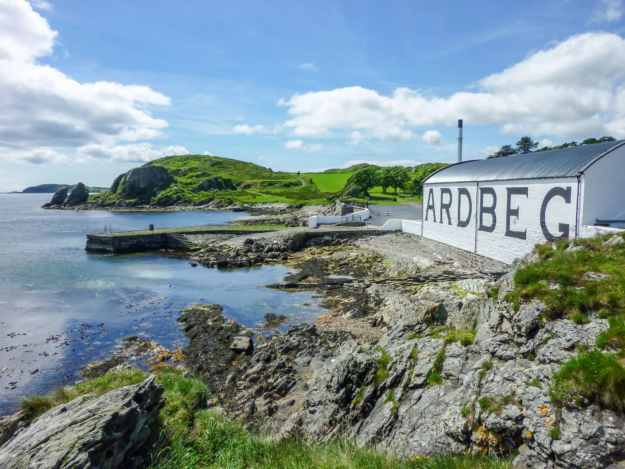 The sun shines on the Ardbeg distillery warehouse on Islay, Scotland.
