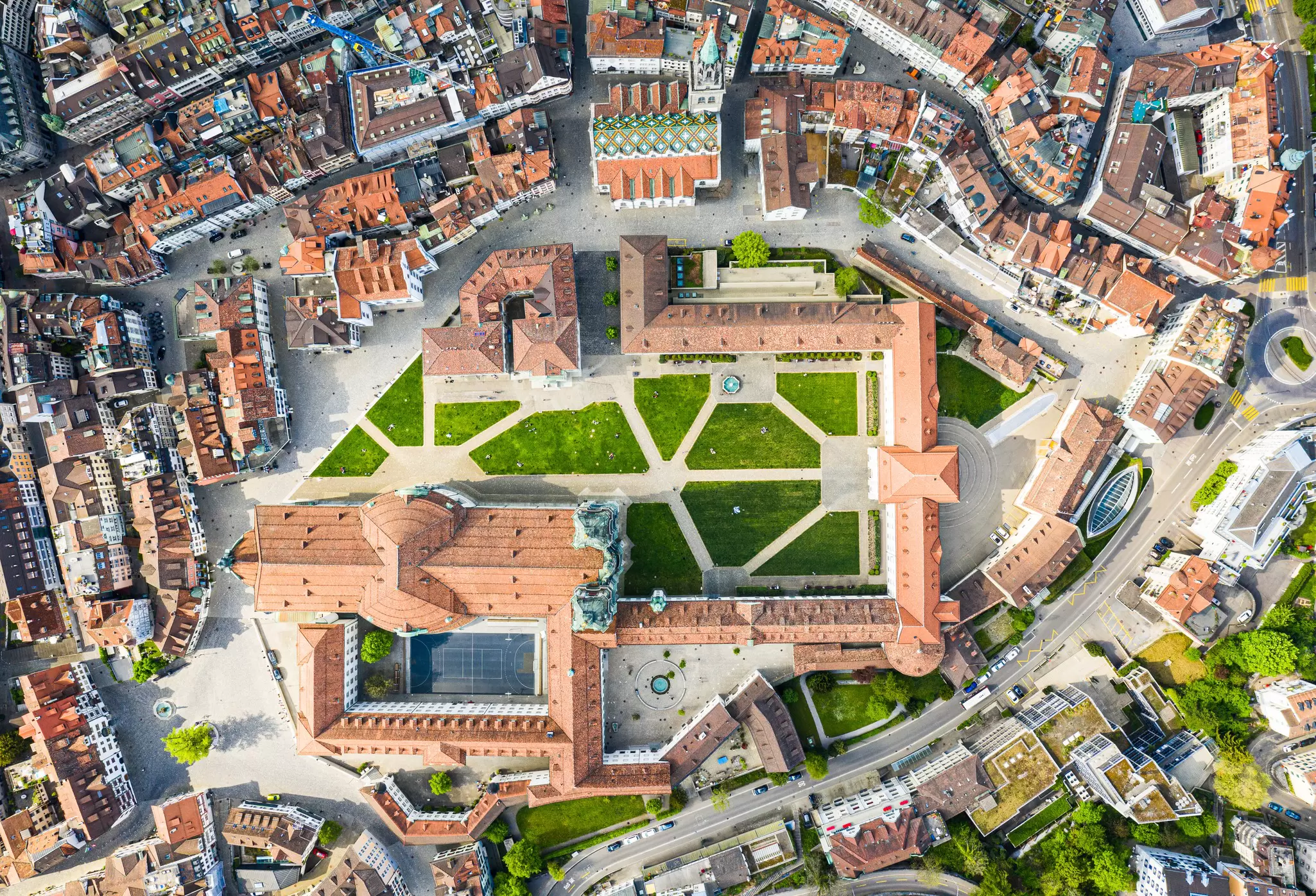 An aerial, top-down view of St Gallen Abbey, which is located in the centre of the city's old town. The old monastery is a square complex of buildings and contains what is now a cathedral.