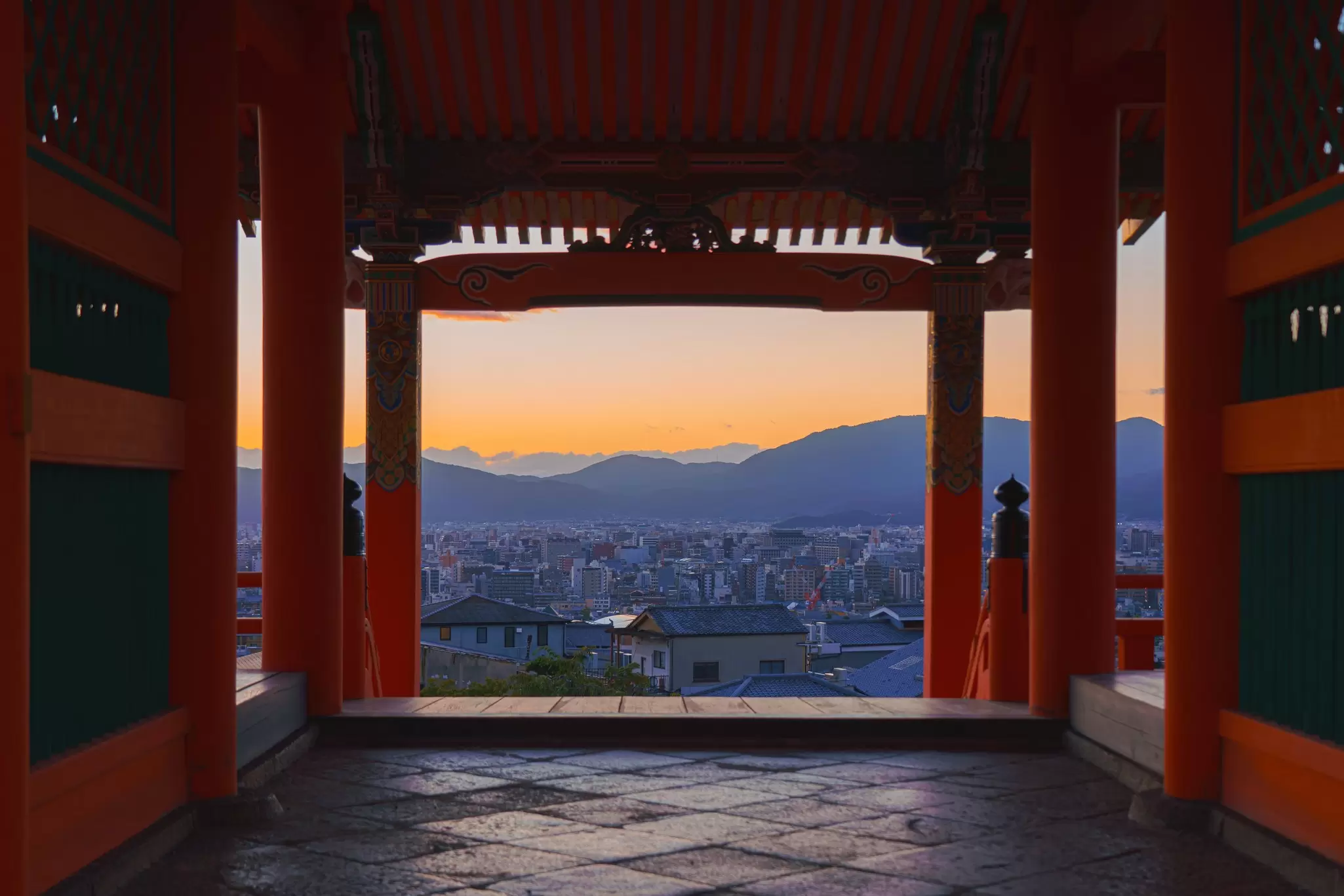 Kyoto, Japan - Sep 23 2024, Panoramic view through entrance gate of Kiyomizu Dera Pure Water Temple to evening Kyoto city with mountain in background at sunset orange sky, without people, Kyoto, Japan, License Type: media, Download Time: 2025-02-27T17:52:50.000Z, User: katelyn.perry_lonelyplanet, Editorial: true, purchase_order: 65050 - Digital Destinations and Articles, job: wip, client: wip, other: Katelyn Perry