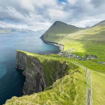 A plunging landscape of sea cliffs and grassland near Gjogv in the Faroe Islands. 