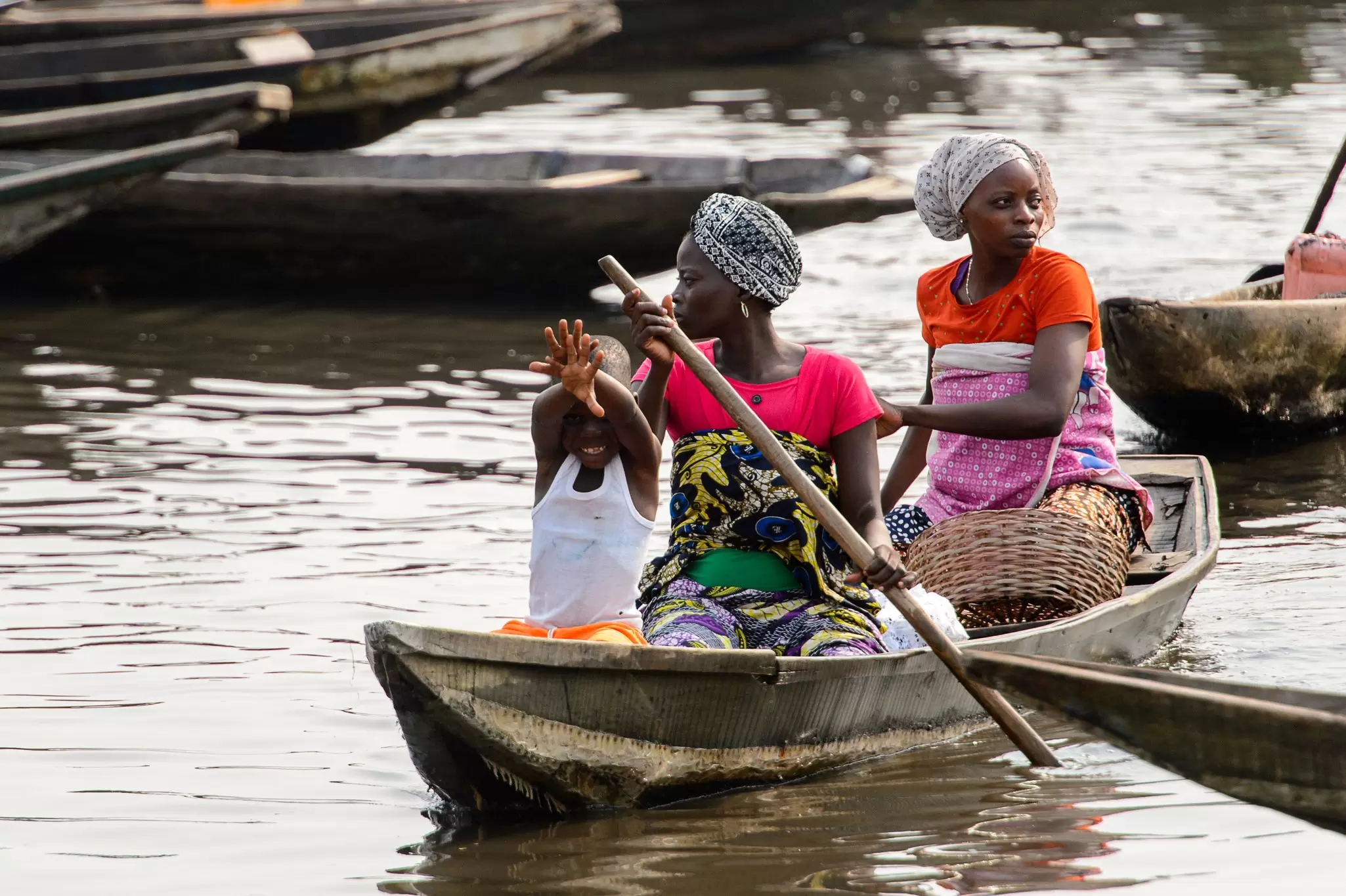 Women paddle a canoe through the stilt village of Ganvie, Benin. Anton_Ivanov/Shutterstock