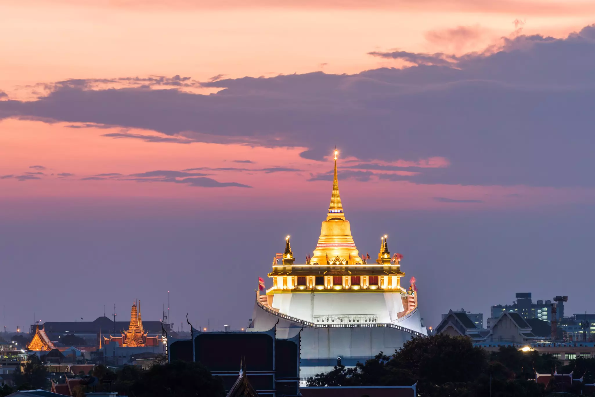 The Golden Mount during a rich sunset with other buildings in the foreground and background