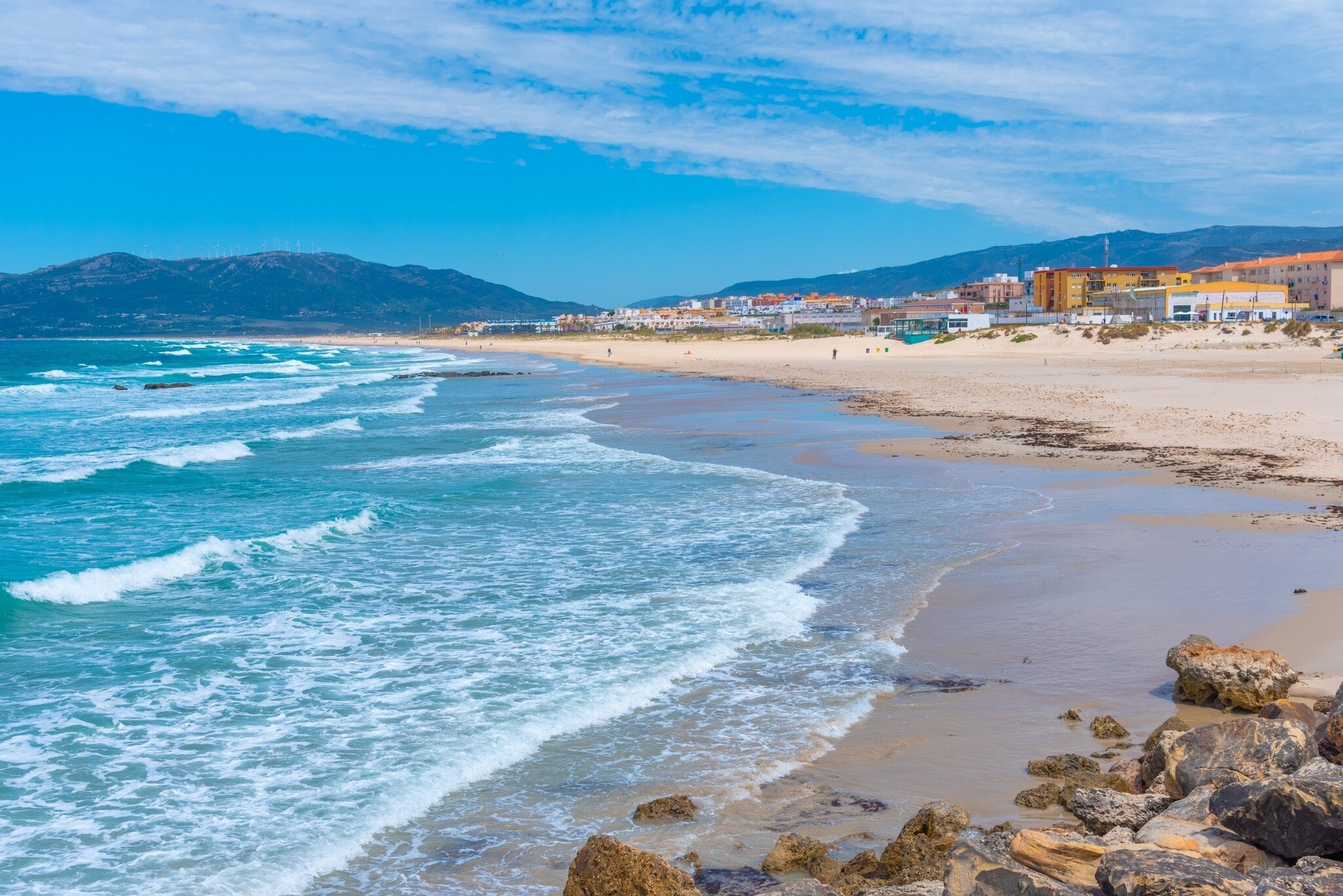 View of waves pulling onto the shore at Playa de los Lances in Tarifa, Spain.