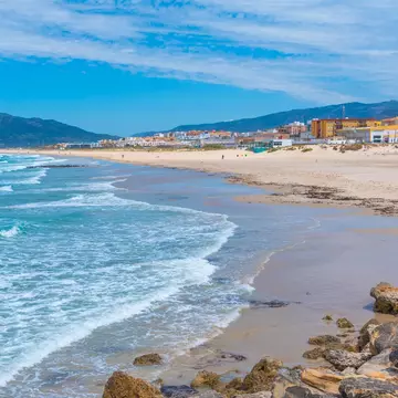 View of waves pulling onto the shore at Playa de los Lances in Tarifa, Spain.
