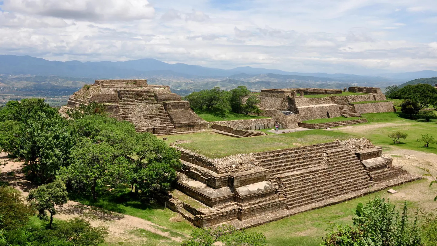 The restored ruins of an ancient city, with platforms, stairways and lawns.