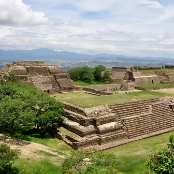 The restored ruins of an ancient city, with platforms, stairways and lawns.