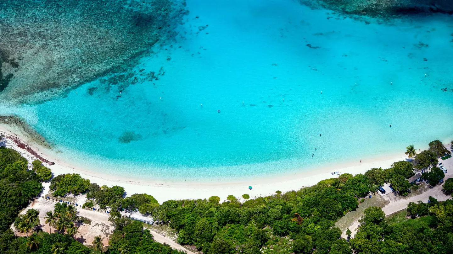 Aerial view of the turquoise water and white sand crescent at Lindquist Beach in St.Thomas, US Virgin Islands