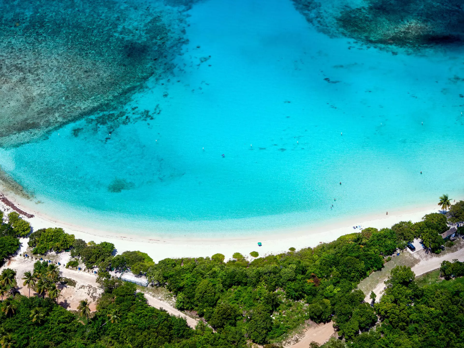 Aerial view of the turquoise water and white sand crescent at Lindquist Beach in St.Thomas, US Virgin Islands