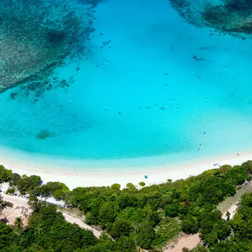 Aerial view of the turquoise water and white sand crescent at Lindquist Beach in St.Thomas, US Virgin Islands