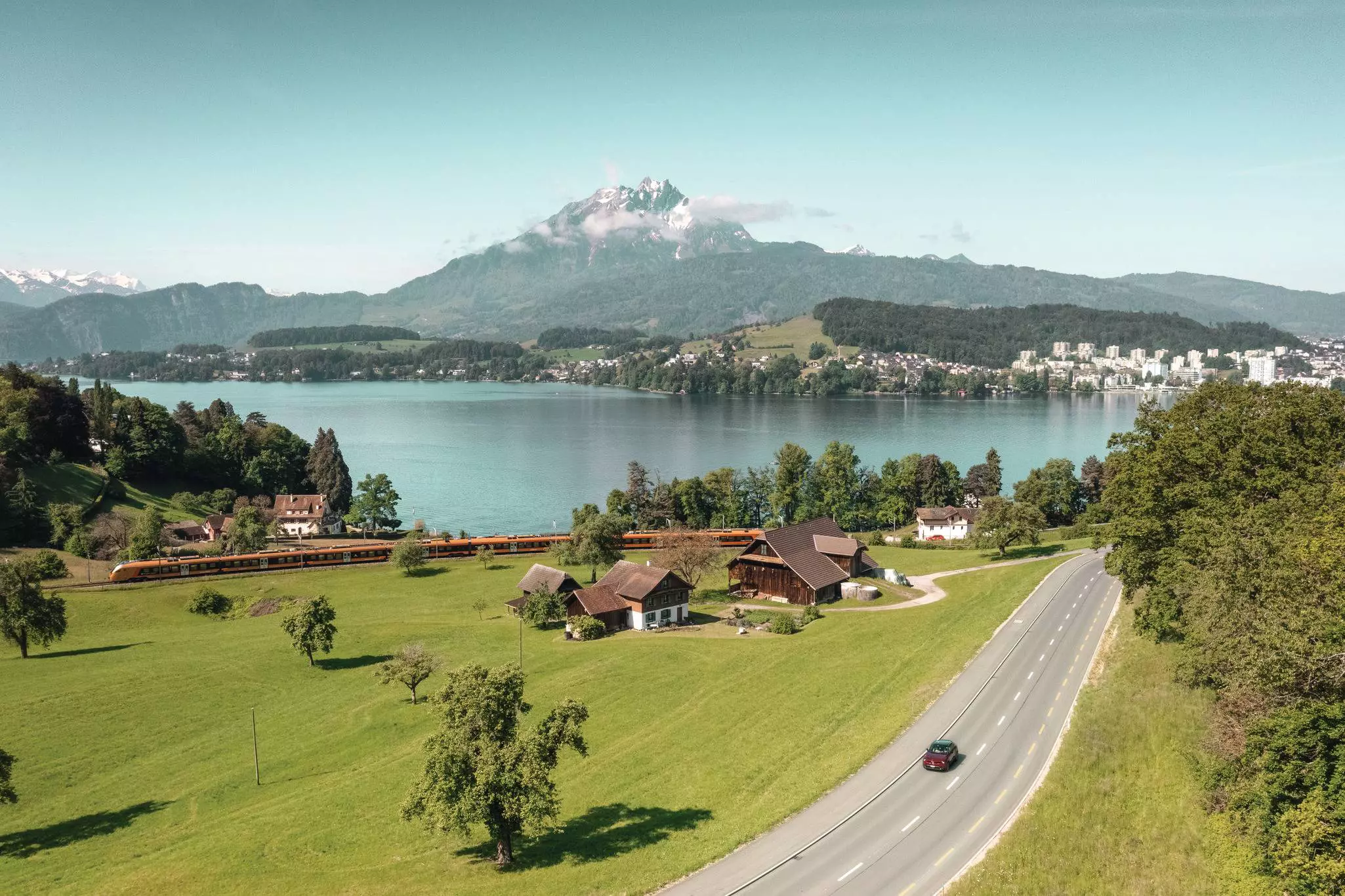 Panoramic Landscape View of Lake Lucerne and mountain ranges from Rigi Kulm viewpoint, Lucerne, Switzerland, Europe. Travel thru beautiful Swiss alpine scenery toward top of majestic mountain peaks.  