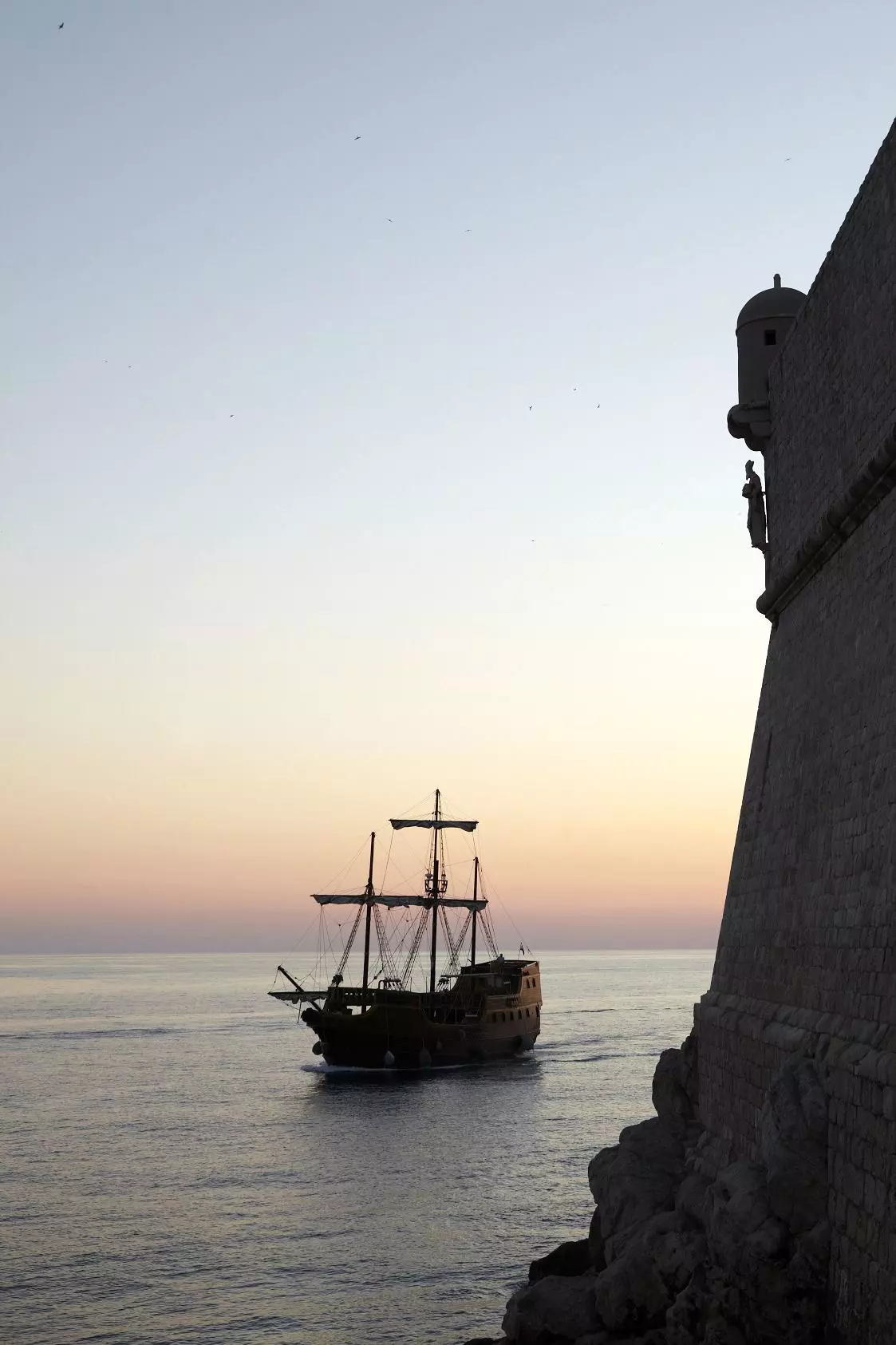 Ship sailing past fortifications of St John (Mark Read/Lonely Planet)