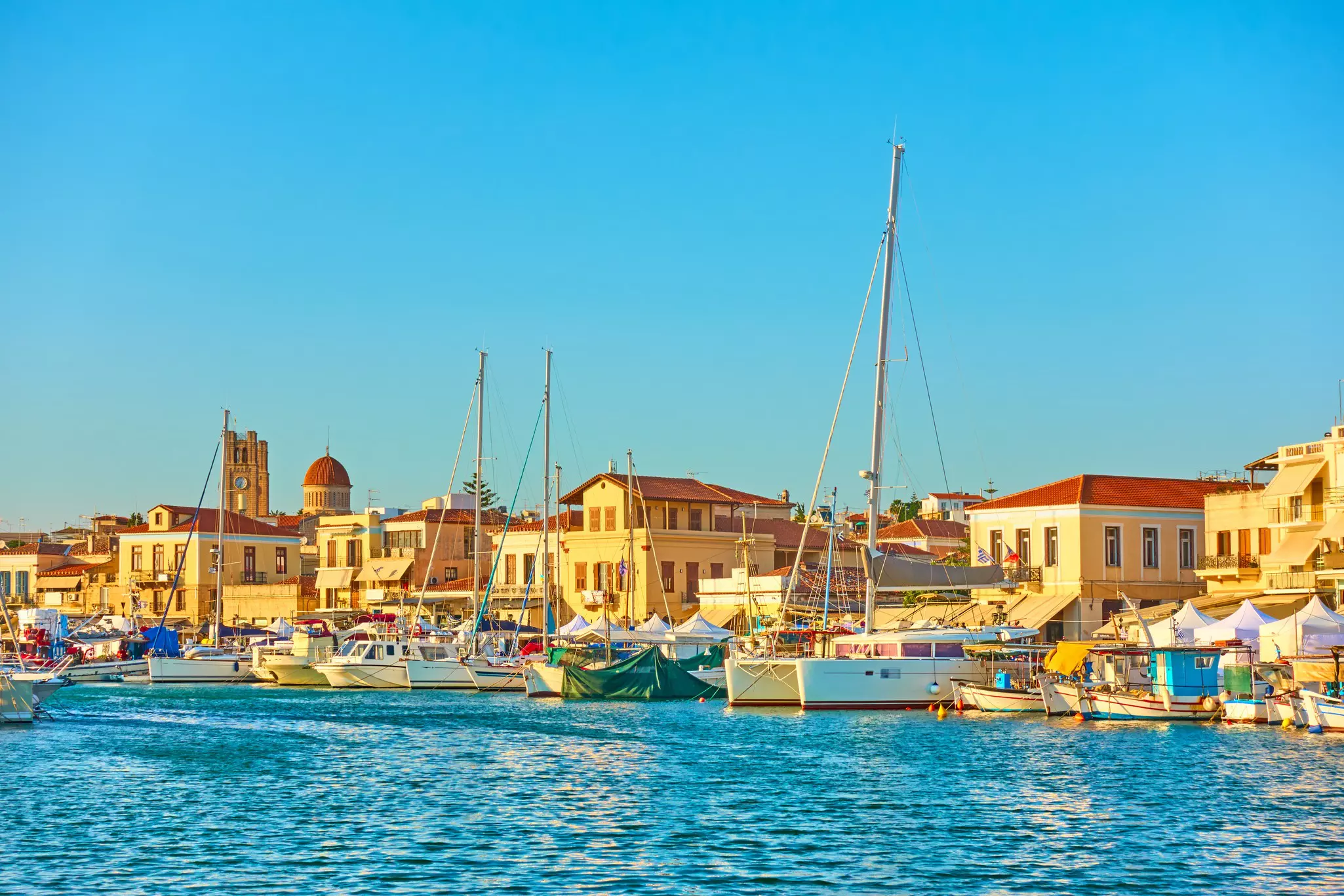 Yachts and boats in a harbor and waterfront at sunset