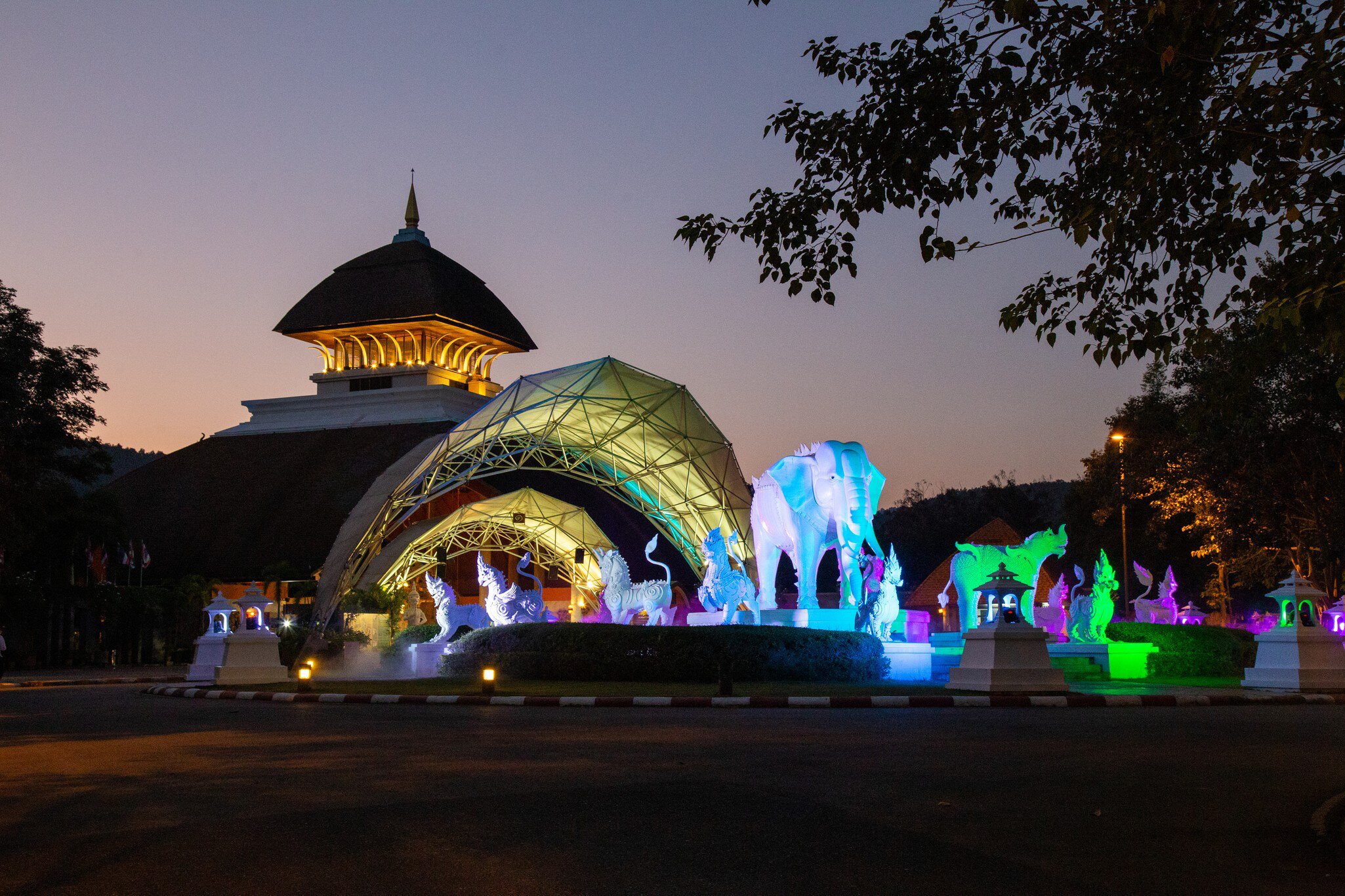 Entrance of Chiang Mai Night Safari in Chiangmai Province, Thailand after sunset with twilight light. Animal sculptures lit with neon lighting.