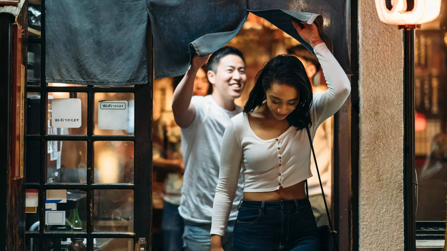 Young couple leaving restaurant in Tokyo