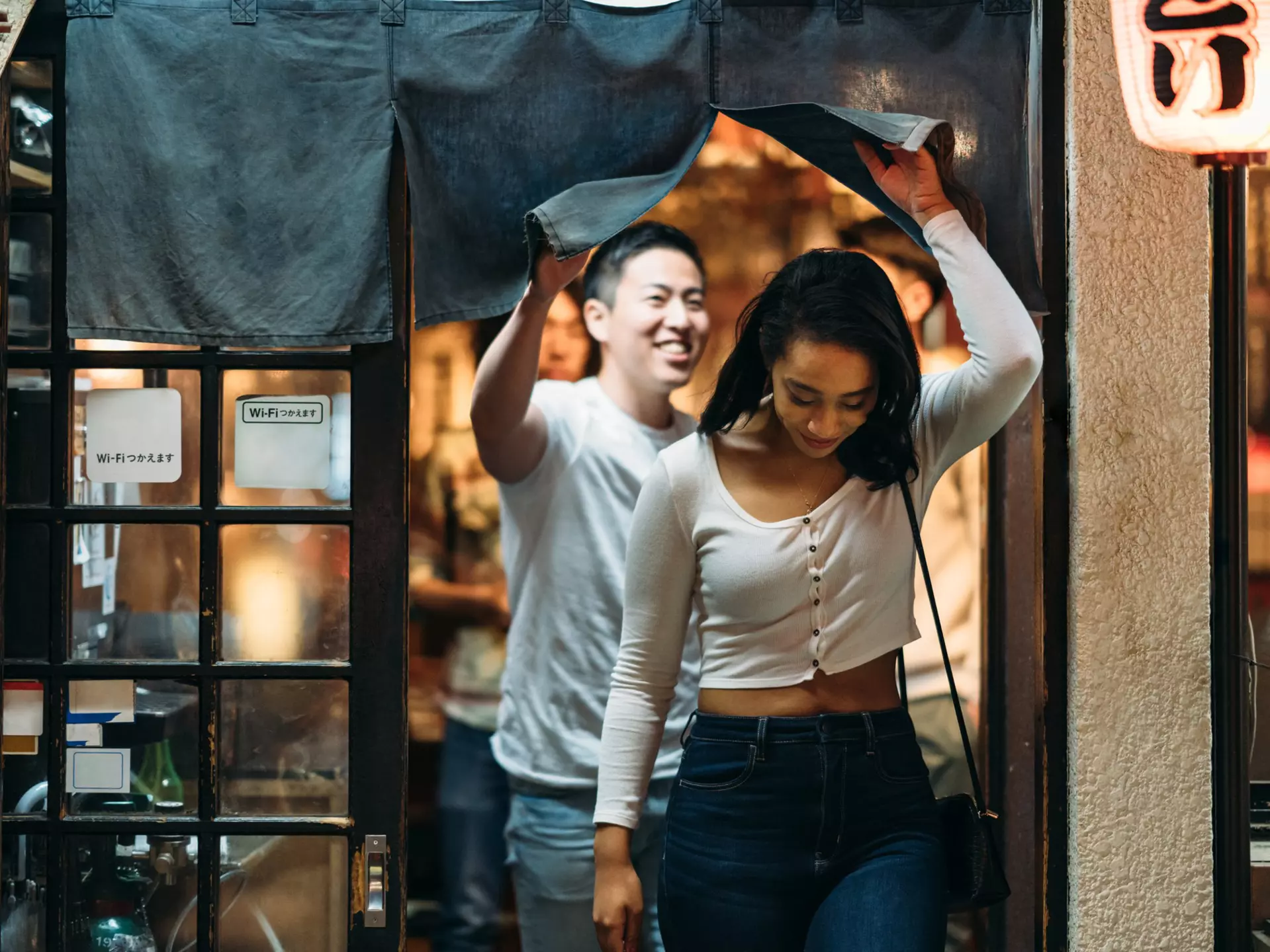 Young couple leaving restaurant in Tokyo