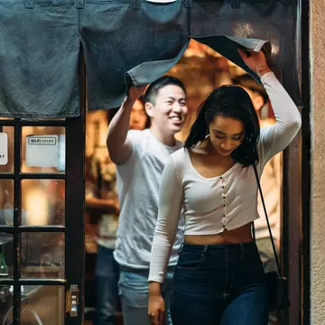Young couple leaving restaurant in Tokyo