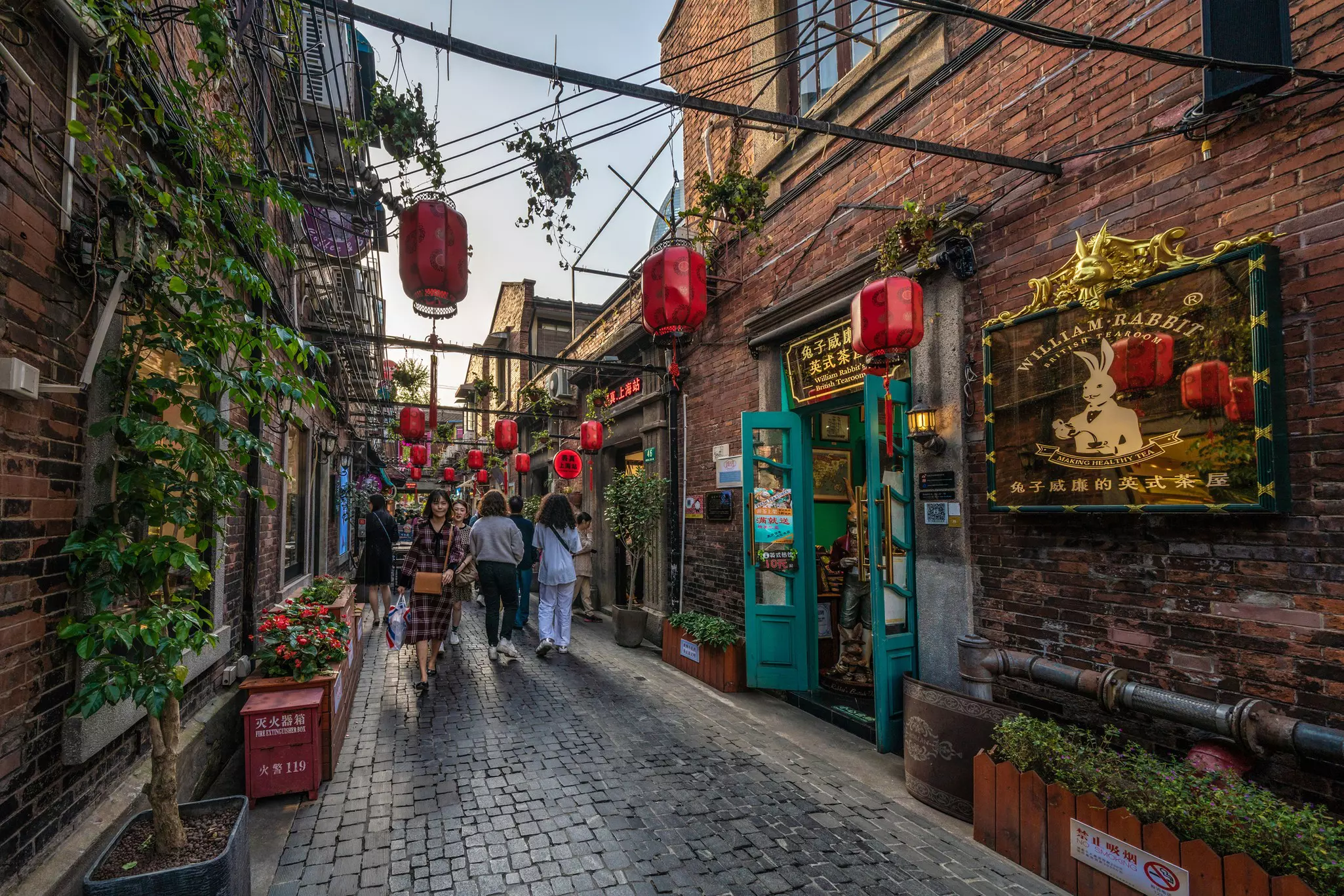 People walking in a lane in the Tianzifang district in Shanghai, China.