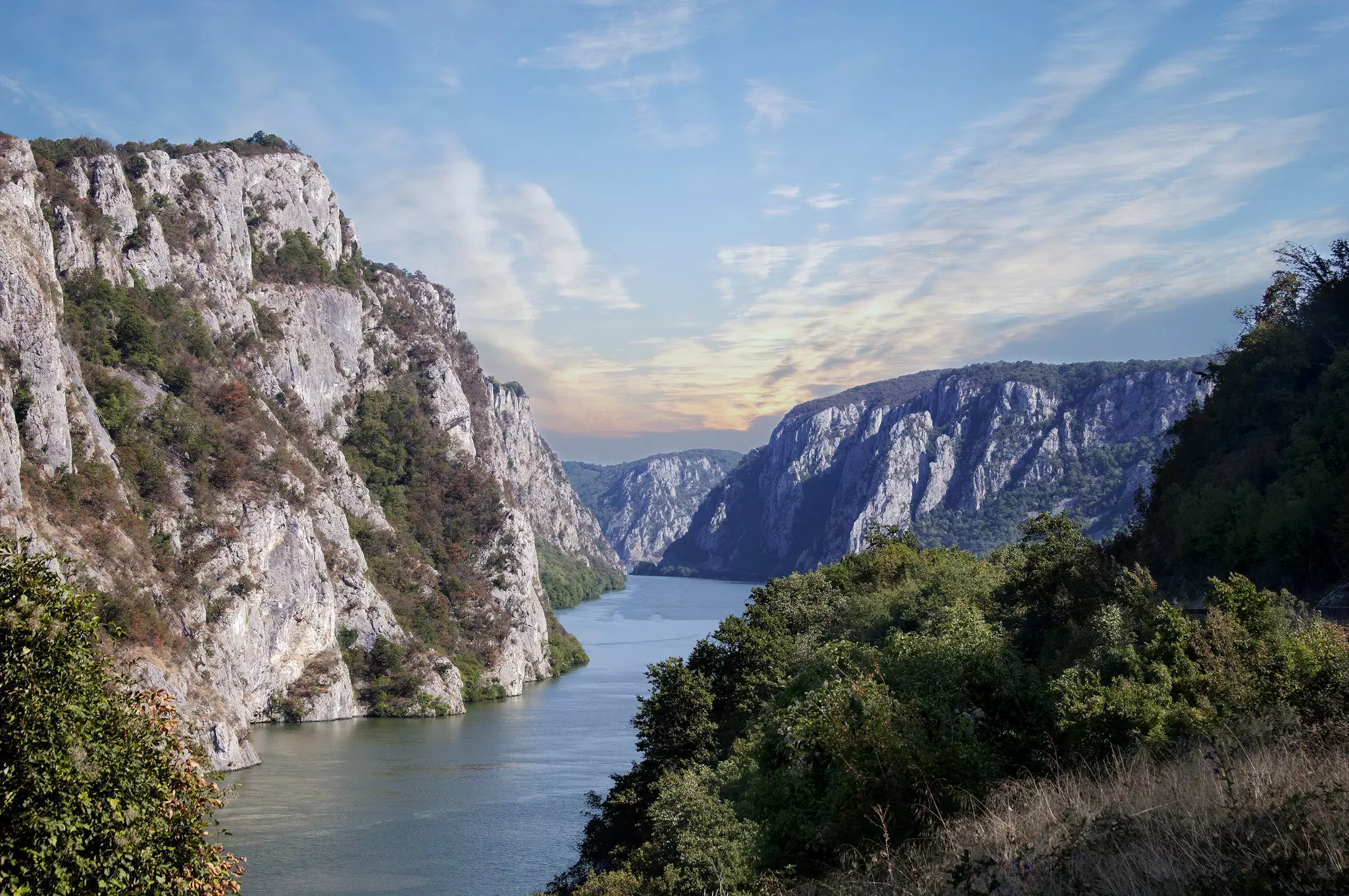 A wide river weaves its way through a high-sided gorge.