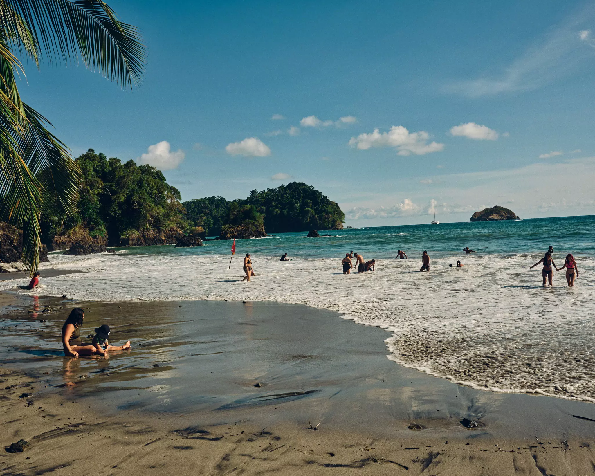 Families having fun on Espadilla Beach in Costa Rica