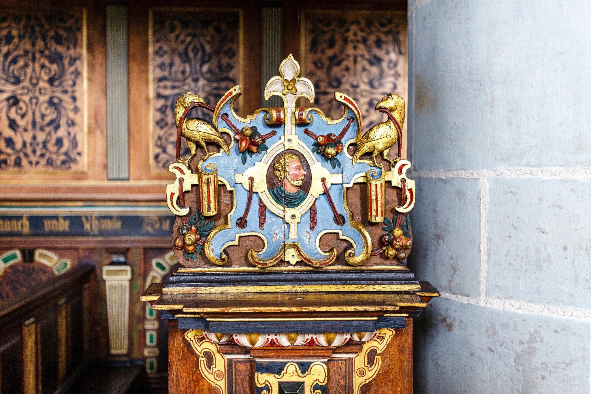Detail of pew with rich ornate  colorful woodwork in the chapel of Kronborg Slot castle in Helsingor, Denmark.