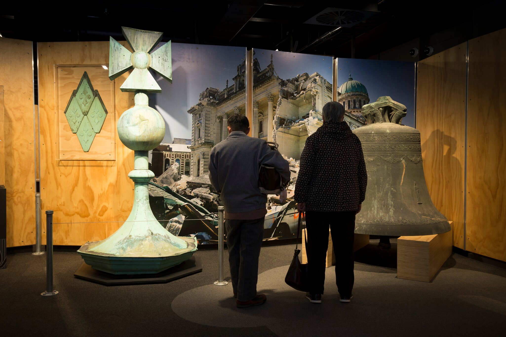 Two main admire artefacts on display from Quake City in the Canterbury Museum in Christchurch, New Zealand.