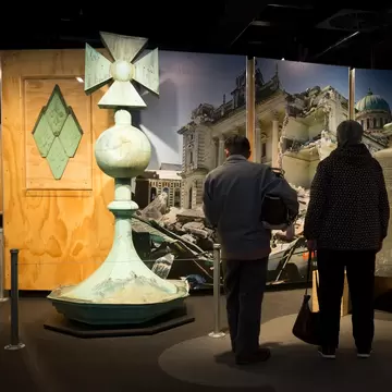 Two main admire artefacts on display from Quake City in the Canterbury Museum in Christchurch, New Zealand.