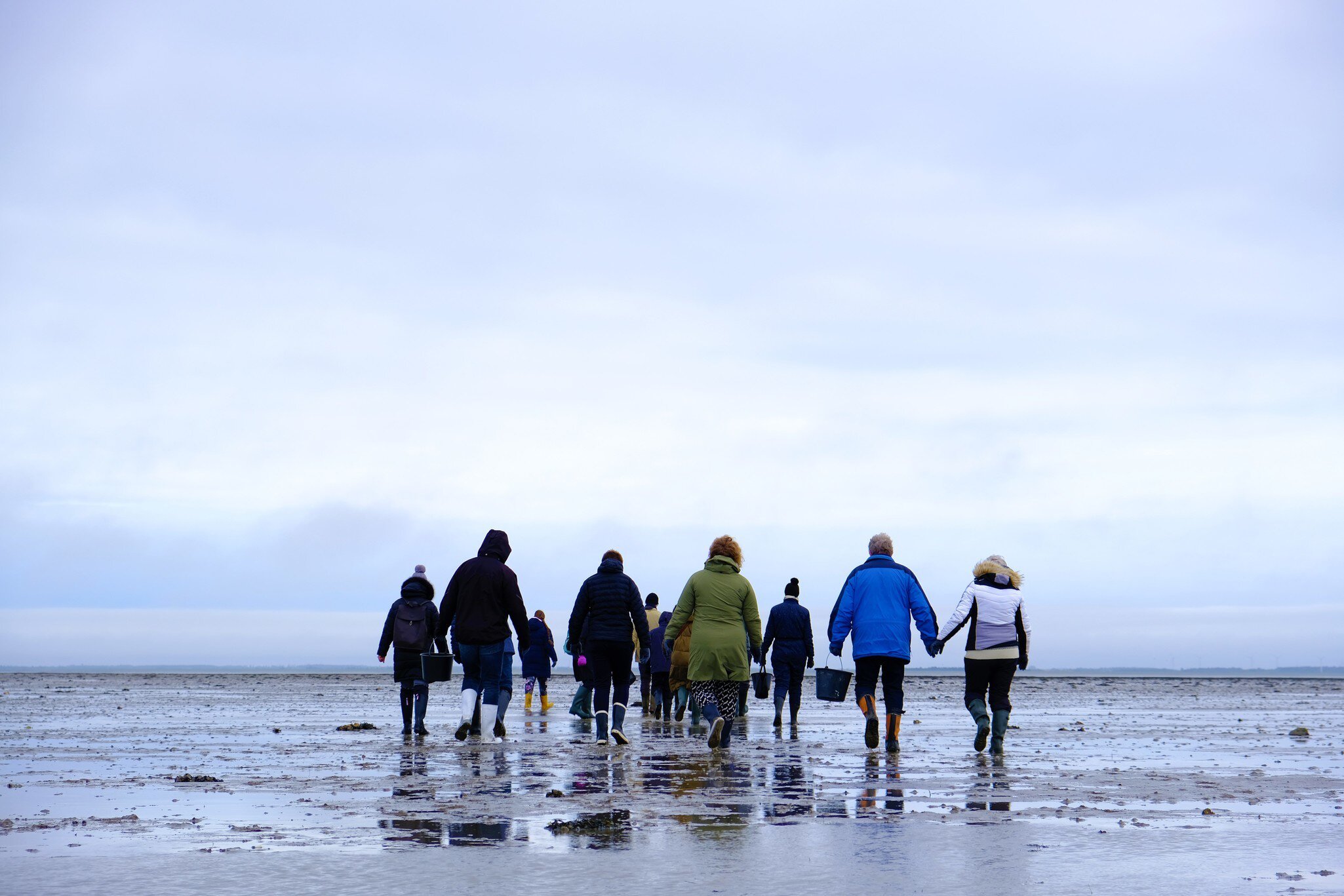 People walking in cold weather as part of Naturcenter Tønnisgaard in Rømø, Jutland, Denmark.
