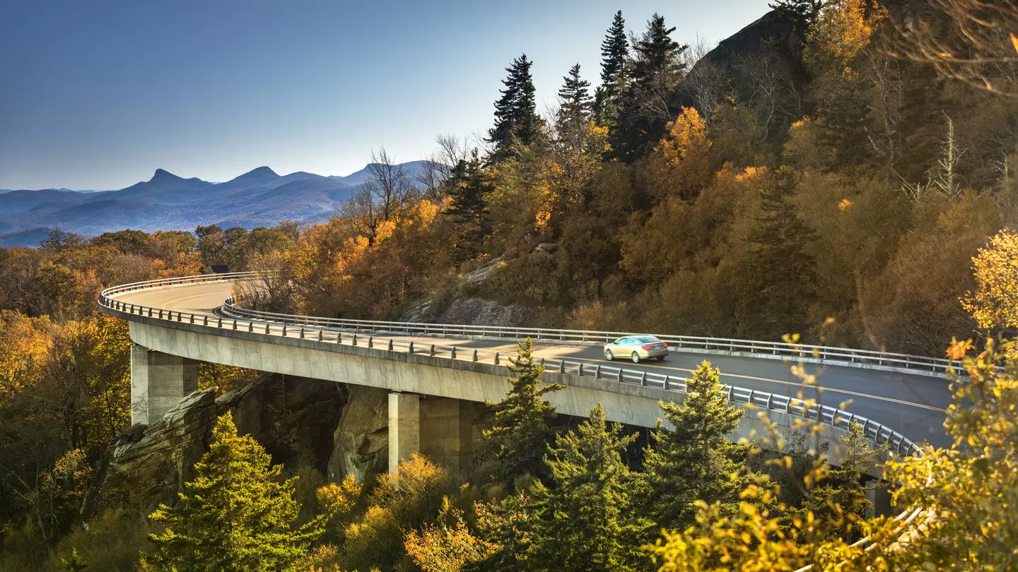 Cars travel on the Linn Cove Viaduct along the Blue Ridge Parkway in fall, North Carolina
