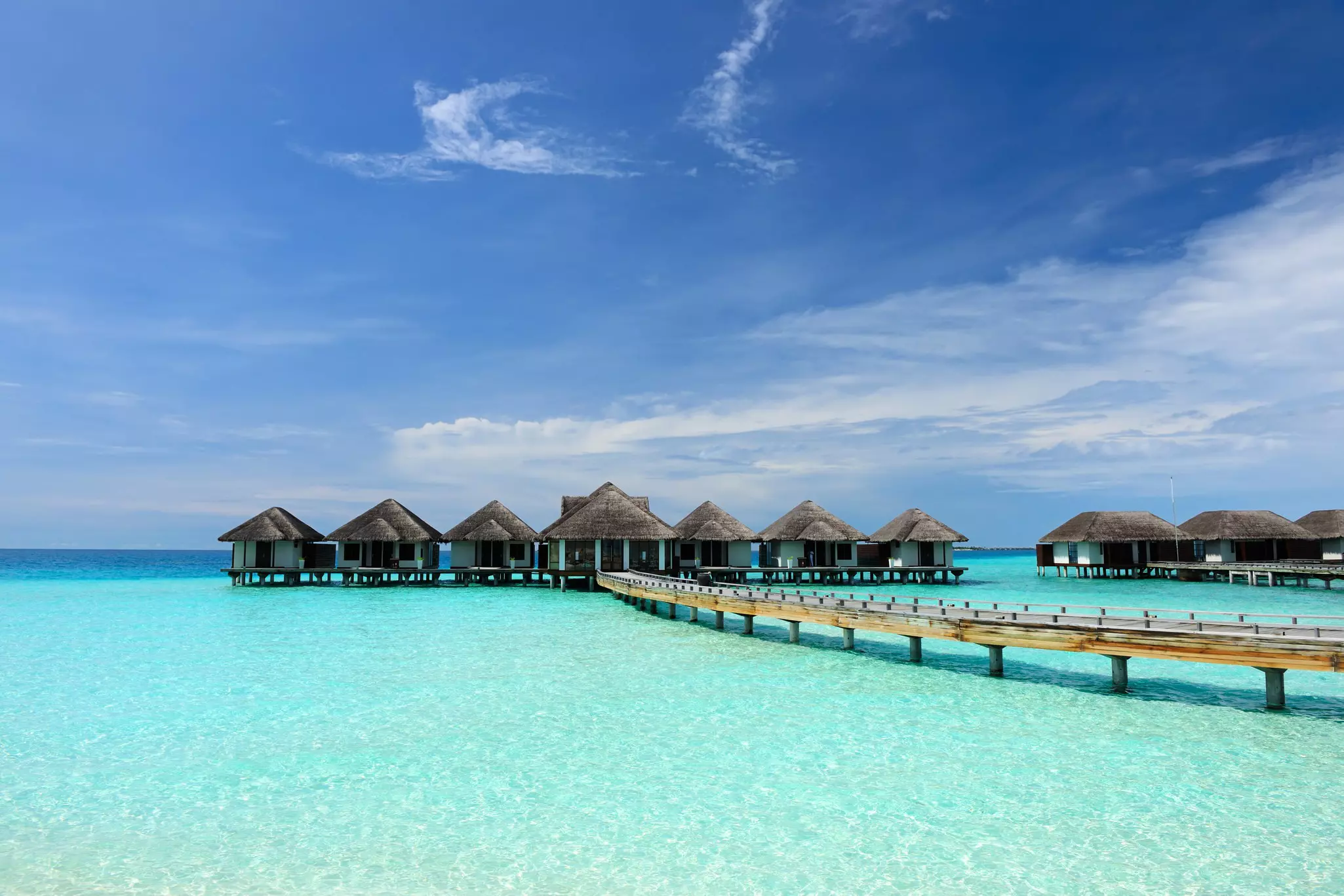 A beautiful beach with over-water bungalows in Maldives