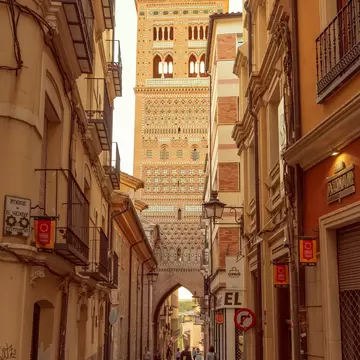 View of Torre de El Salvador from a narrow street in Teruel, Spain.