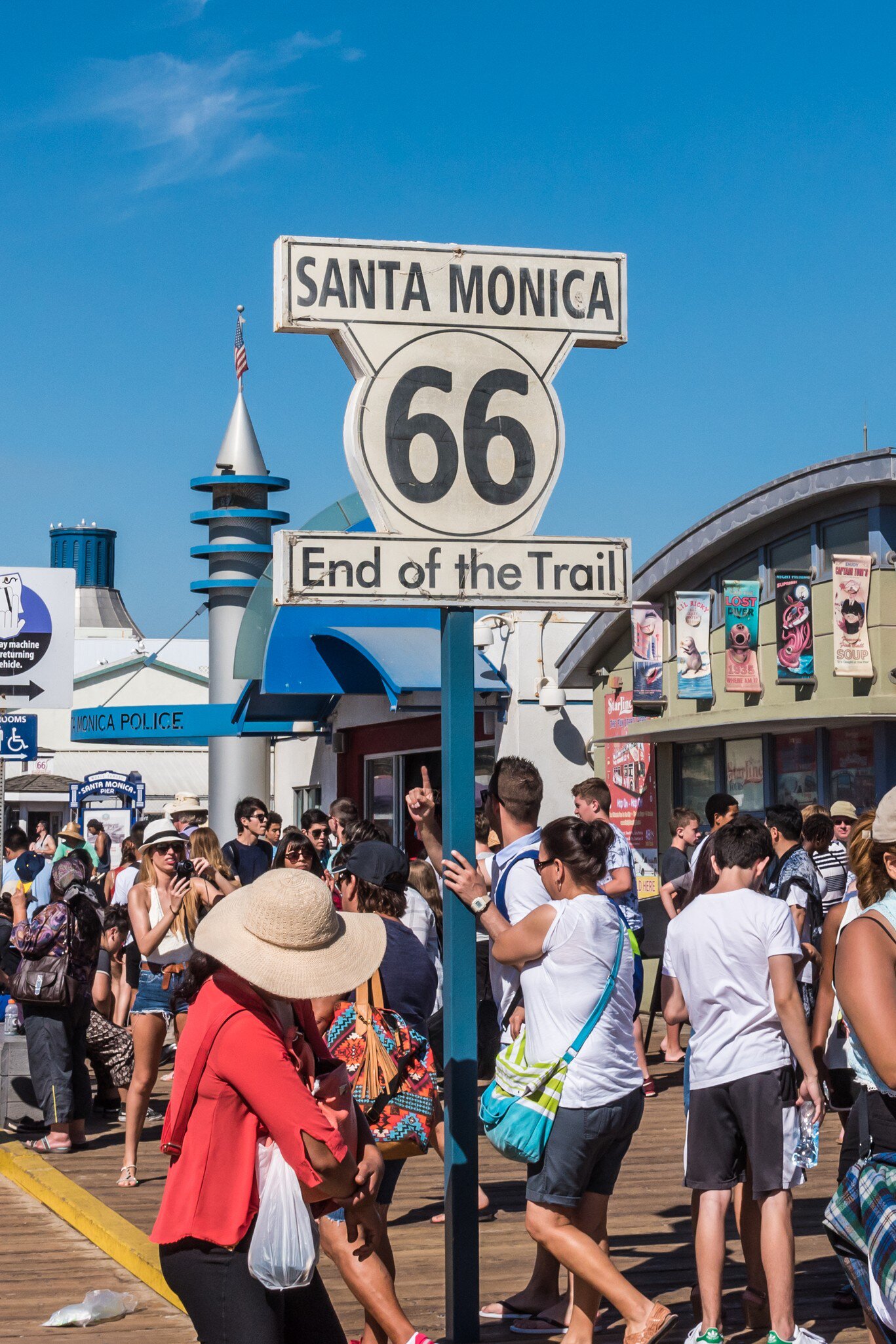 Santa Monica, California, USA - July 22, 2016: Tourists visit the Santa Monica Pier, the "End of the Trail" of the famous Route 66.  License Type: media  Download Time: 2023-06-14T12:16:09.000Z  User: dermothegarty77  Is Editorial: Yes  purchase_order: 56530  